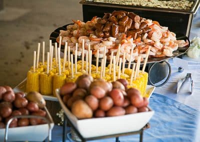 Ascik Wedding | a buffet table with corn on a stick, hostdogs, more