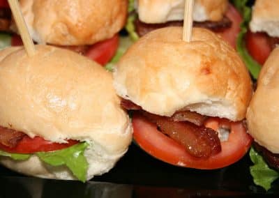 a group of burger with bacon and tomatoes