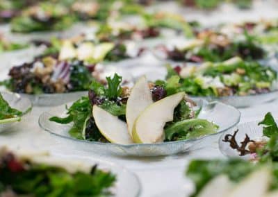Chefs Table Dignity Health Party | a plate of salad with pears on it