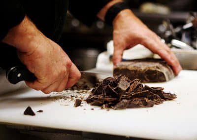 catering santa maria | a person cutting chocolate on a counter
